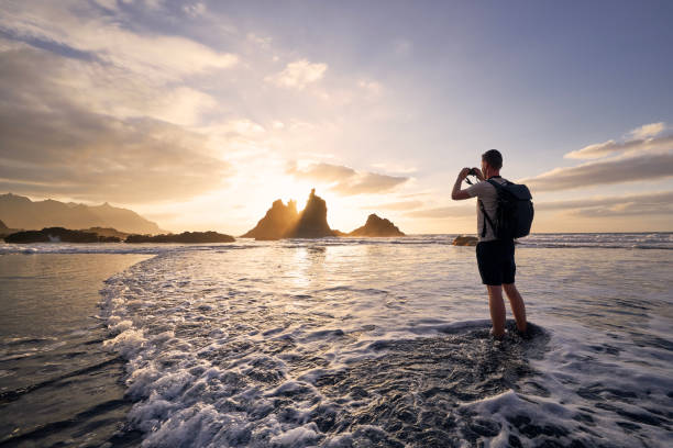 istock Man during photographing landscape with cliff at sunset