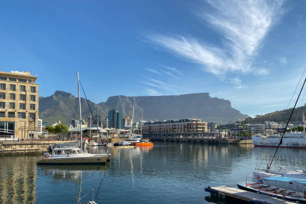 scenic view of victoria and alfred waterfront (w&a waterfront) against table mountain and blue sky - victoria and alfred imagens e fotografias de stock