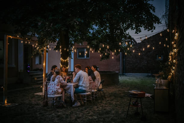 friends on dinner party in back yard - 燈串 個照片及圖片檔