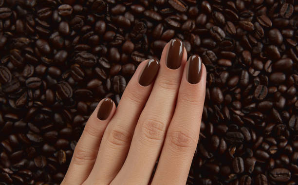 istock Beautiful groomed womans hand with brown nail design 1327788043