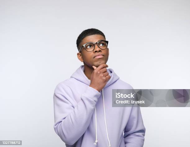 Thoughtful Young Man Wearing Lilac Hoodie Stock Photo - Download Image Now - Contemplation, White Background, Generation Z