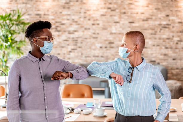 istock Colleagues in the office practicing alternative greeting for safety and protection during COVID-19 1327790287