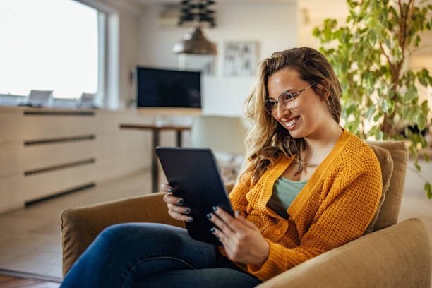 istock Adult woman, having fun on her tablet, alone. 1327791226