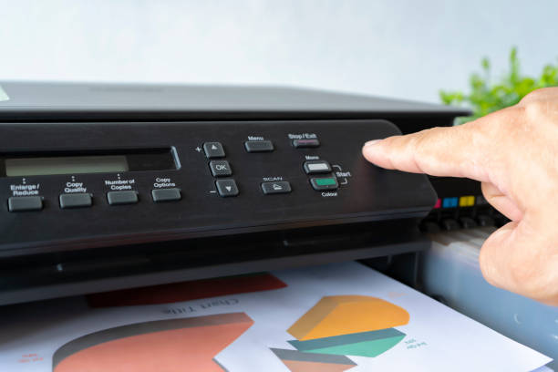 istock Fingers that are pressing the button, The printer is fully functional,Located on the desk. 1327791689