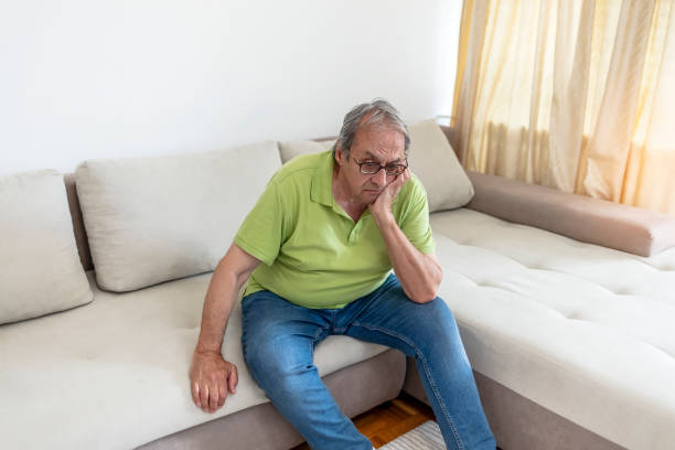 istock Worried senior man sitting alone in his home 1327793459