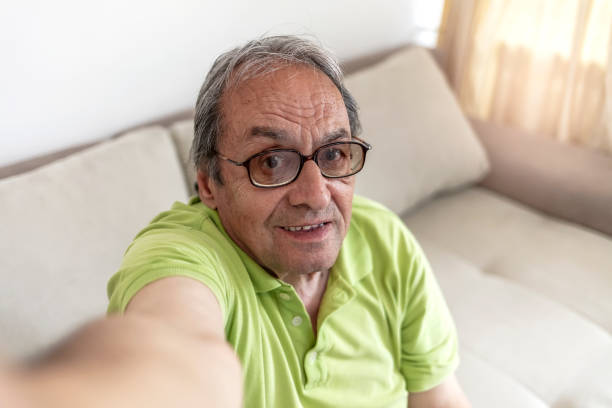 istock Senior man taking selfie at home. 1327793662