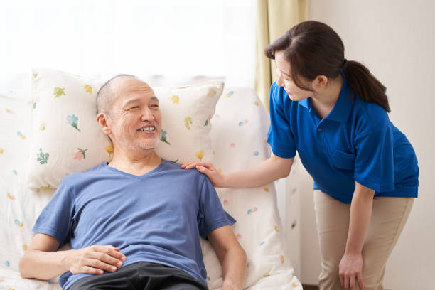 istock Smiley caregiver and the elderly 1327794636
