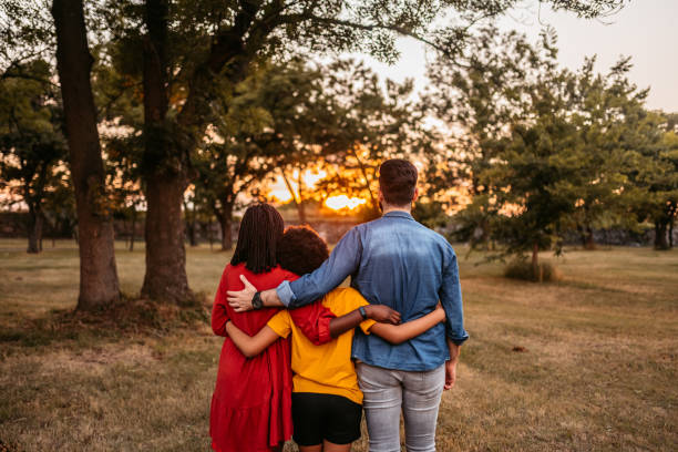 istock Embraced multi-ethnic family together in the park 1327795584