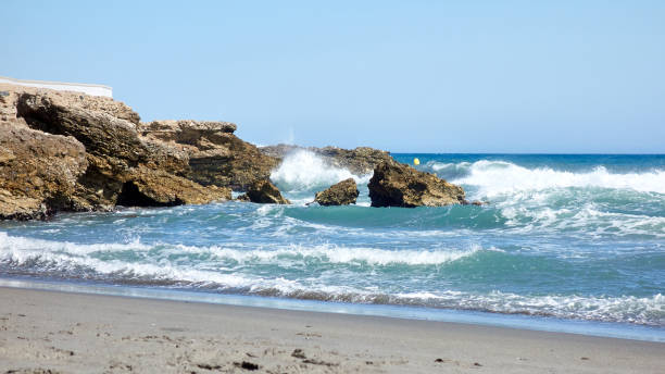istock Waves crashing against a breakwater 1327798446