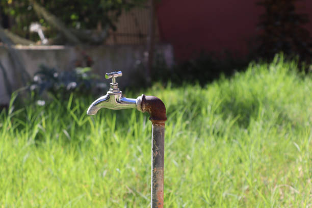 Outdoor faucet in the garden. Old metal tap in the park.