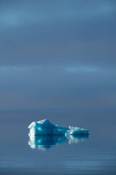 istock On a rare, wind-still day, an iceberg appears to float on a horizonless sea 1327800799