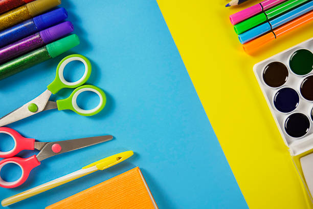 istock Colored pencils, scissors. School office on a yellow blue background. copy space 1327801821