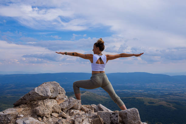 istock Feeling free and strong while doing warrior yoga pose in wild nature 1327808055