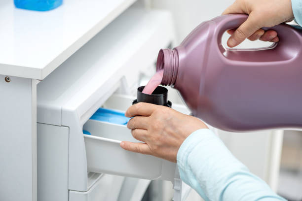 istock Woman is holding liquid washing machine detergent. 1327809050