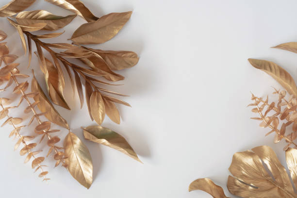 istock Gold tropical palm leaves Monstera on white background. Flat lay 1327810181