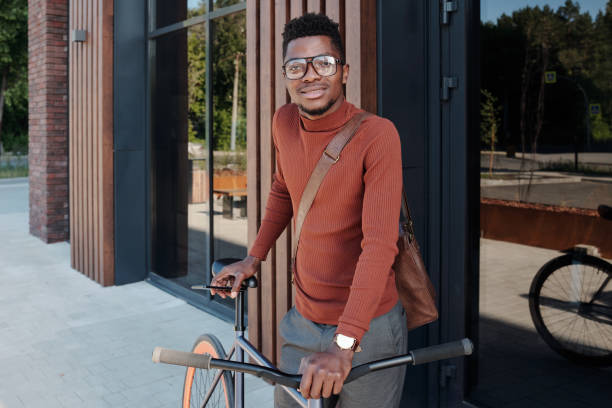istock Young man of African ethnicity with bicycle 1327810703