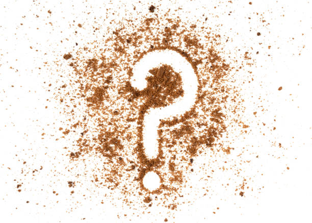 Brown biscuits crumbs with a question mark sign isolated on white background.
