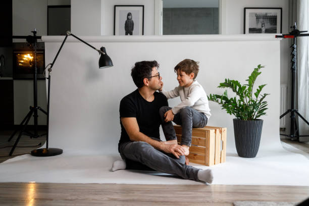 Father and son Father and son are posing in an improvised photo studio in their living room. fashionable dad stock pictures, royalty-free photos & images