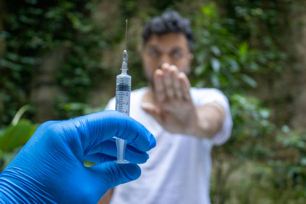 Man refusing to get injection of vaccine for Corona Virus Anti-vaccination, COVID-19 Vaccine, COVID-19, Vaccination, Pandemic - Illness anti vaccination stock pictures, royalty-free photos & images