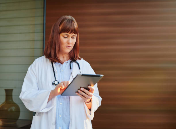 istock Shot of a young doctor using a digital tablet on the balcony 1327814442