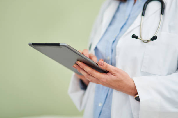 istock Shot of an unrecognisable doctor using a digital tablet against a green background 1327814496