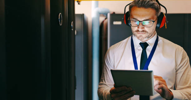 istock Shot of a male technician using a digital tablet while working in a server room 1327815543