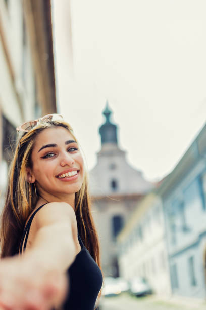 istock Girl turning back to her partner exploring old town 1327815546