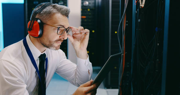 istock Shot of a male technician using a digital tablet while working in a server room 1327816097