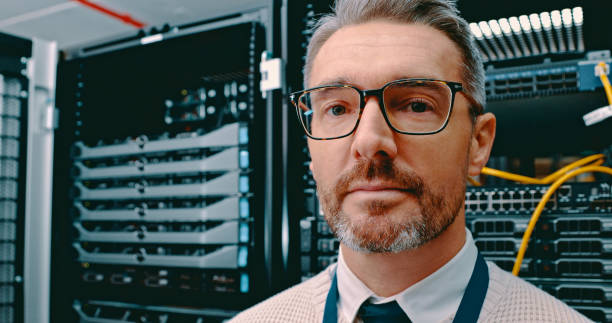 istock Shot of a mature man working in a server room 1327816186