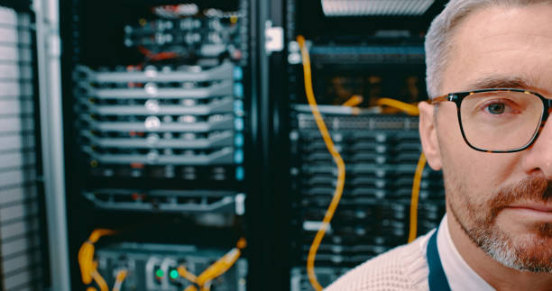 istock Shot of a mature man working in a server room 1327816192