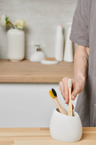 istock Young woman taking one of toothbrushes 1327817826