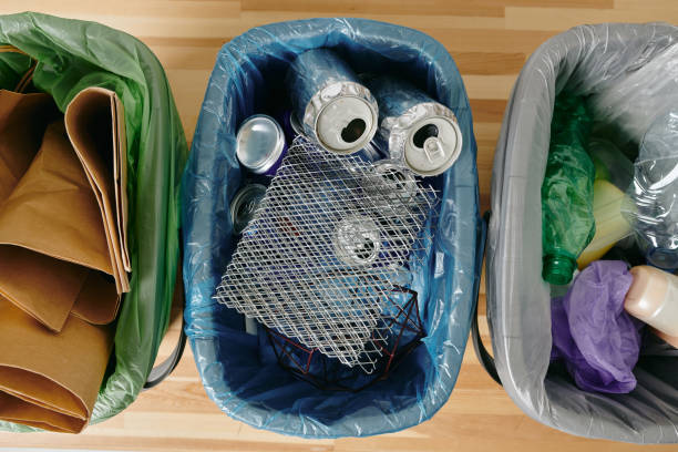 istock Three trash bins with various kinds of garbage 1327817898