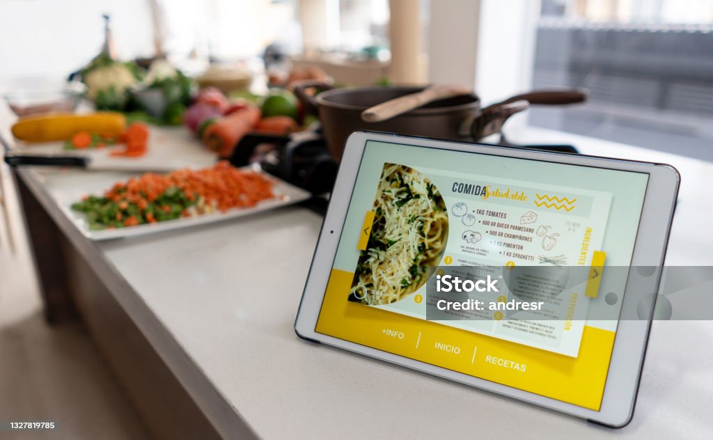 Cooking recipe on a tablet computer Close-up on a tablet computer on the kitchen counter displaying a cooking recipe - using technology concepts. **DESIGN ON SCREEN WAS MADE FROM SCRATCH BY US** Recipe Stock Photo