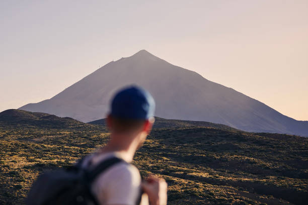 Traveler against landscape with Pico de Teide at dusk