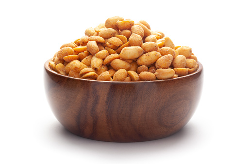Close up of Crunchy masala peanuts Indian namkeen (snacks) In hand-made (handcrafted) wooden bowl.