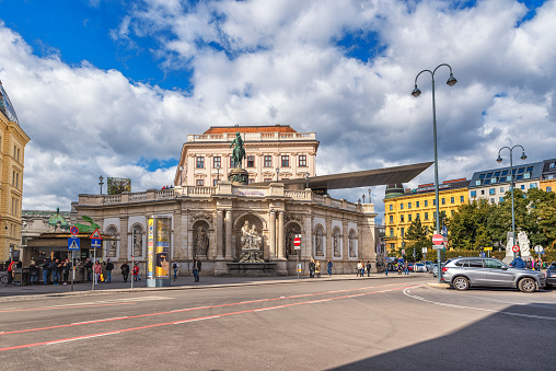 Zurich, Switzerland - September 8, 2019: The tram drives through the main train station in Zurich. Some people walk the sidewalks in a rainy day.