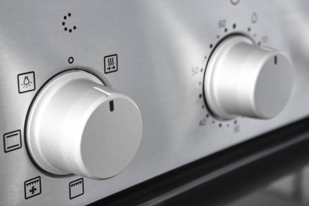 istock Oven cooking temperature control knob. Kitchen equipment panel detail 1327828050