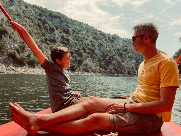 istock Father and son relaxing on boat. 1327829376
