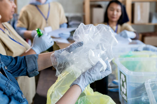 istock Hands of gloved volunteer sorting waste 1327831609