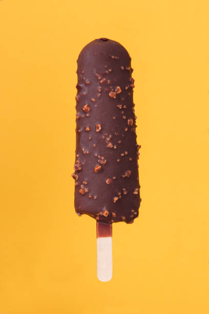 istock dark chocolate almond ice cream on a yellow-orange background 1327835647