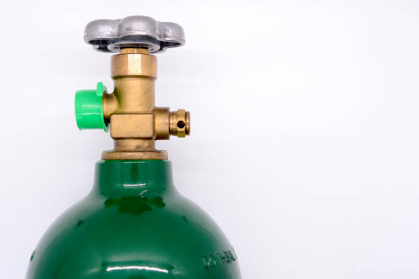 Close-up of medical oxygen tank valve on white background