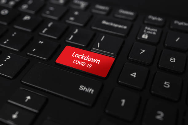 istock lockdown covid-19 button. closeup black keyboard with soft-focus on the background 1327837494