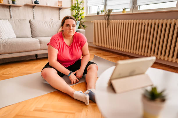 istock Overweight woman making a break in training at home 1327838423