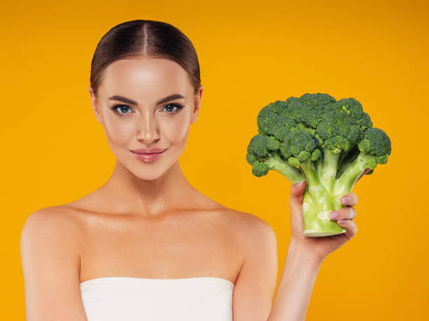 istock Beautiful girl with broccoli 1327841548