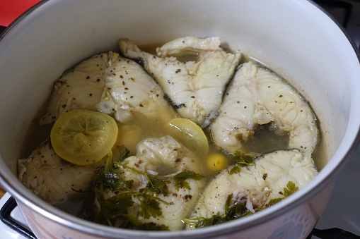 Cod cooked in a court bouillon in a pot  Gastronomic cooking