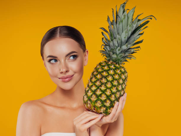 istock Beautiful girl with pineapple 1327842484