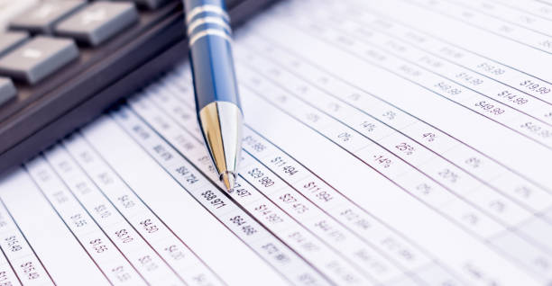 istock financial balance sheet with calculator and pen 1327844318