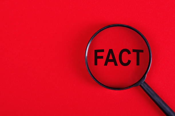 istock Magnifying glass with the inscription FACT on a red background. 1327844322