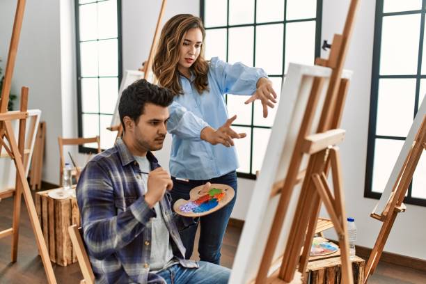 istock Paint teacher teaching to student at art school. 1327844330