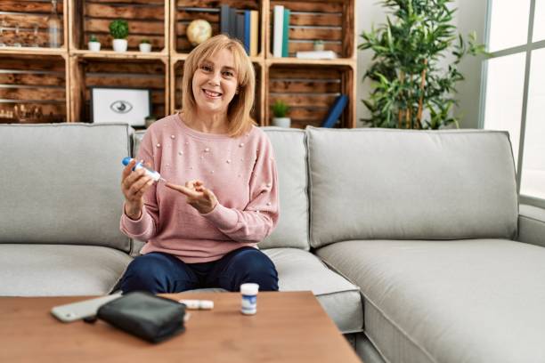 istock Middle age diabetic woman measuiring glucose using glucometer at home. 1327846291